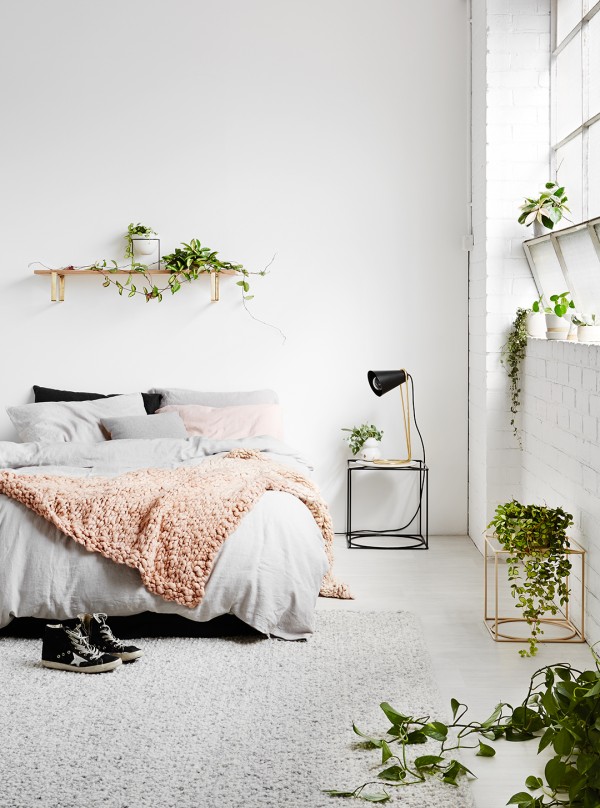 Minimalist floating shelves for flower pots above the bed